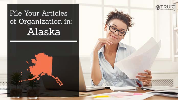 Woman smiling while looking at her articles of organization for Alaska.
