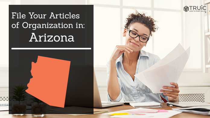 Woman smiling while looking at her articles of organization for Arizona.