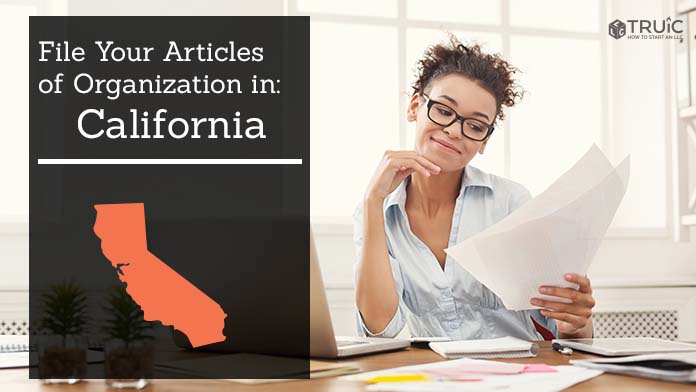 Woman smiling while looking at her articles of organization for California.