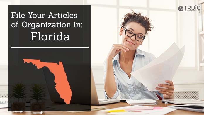 Woman smiling while looking at her articles of organization for Florida.