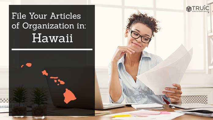 Woman smiling while looking at her articles of organization for Hawaii.