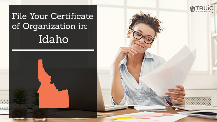 Woman smiling while looking at her certificate of organization for Idaho.