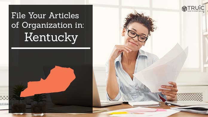 Woman smiling while looking at her articles of organization for Kentucky.
