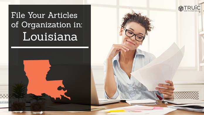 Woman smiling while looking at her articles of organization for Louisiana.