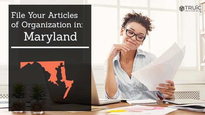 Woman smiling while looking at her articles of organization for Maryland.