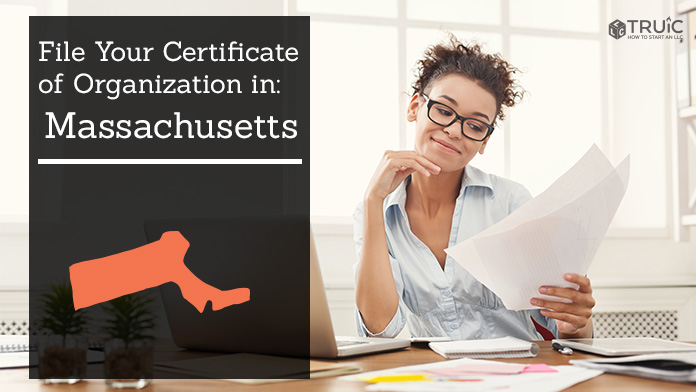 Woman smiling while looking at her certificate of organization for Massachusetts.