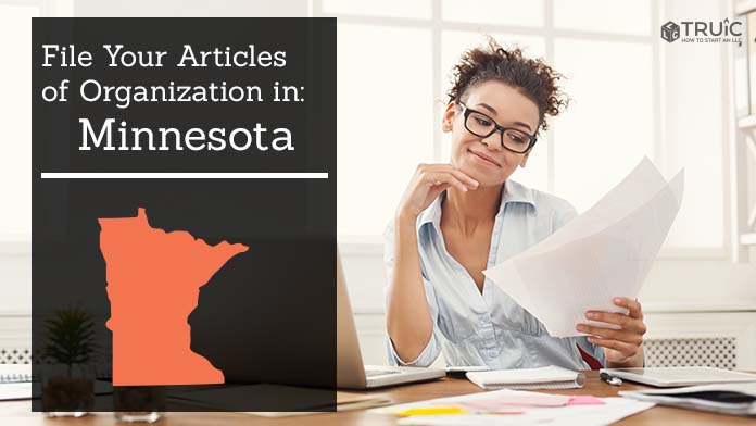 Woman smiling while looking at her articles of organization for Minnesota.