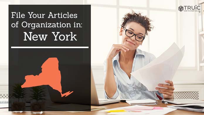 Woman smiling while looking at her articles of organization for New York.