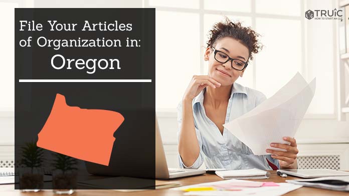 Woman smiling while looking at her articles of organization for Oregon.