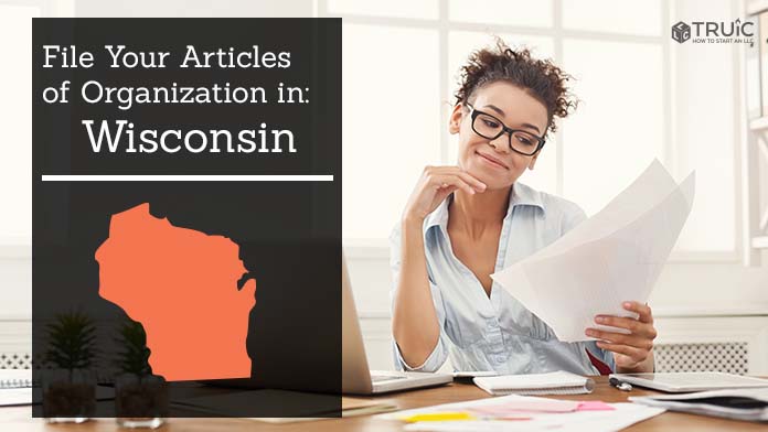 Woman smiling while looking at her articles of organization for Wisconsin.
