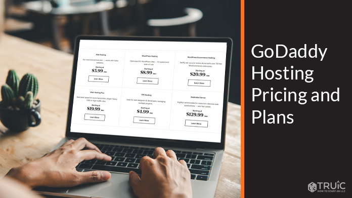 GoDaddy hosting pricing and plans example on laptop.