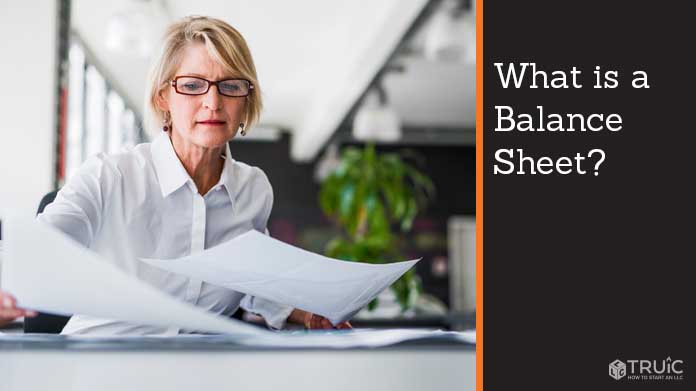 Business woman examining balance sheet.Text to the right reads, "What is a balance sheet?"