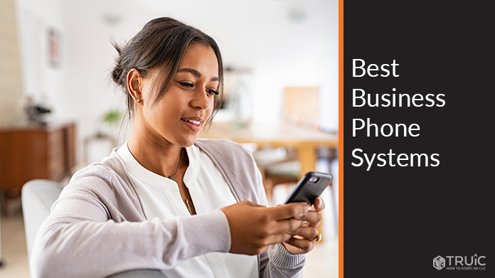 Woman using cell phone to look at best business phone systems.