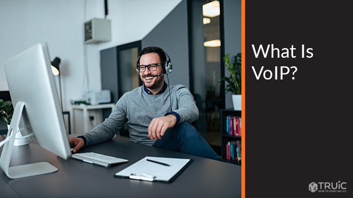 Man talking on VoIP service through his computer.