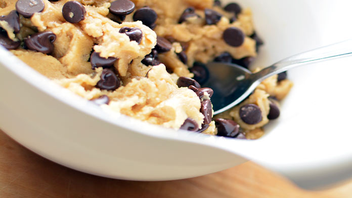 Spoon dipped into a bowl of cookie dough