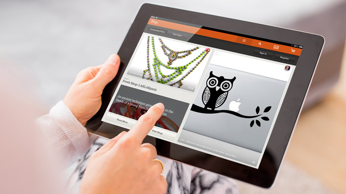 A tablet being held with the Etsy application loaded