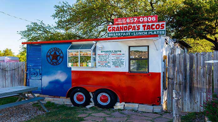 Image of food truck with a sign that reads "Grandpa's Tacos"
