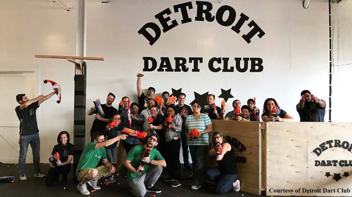 Photo of many people posing for a photo with Nerf guns