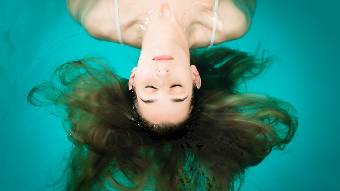 A woman floating on top of water