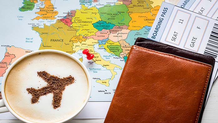 Image of map, airline ticket, and latte with airplane-shaped latte art