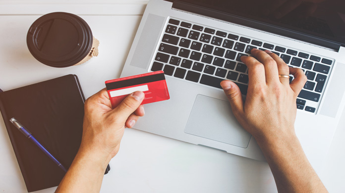 Man learning how to get a business credit card on a laptop.