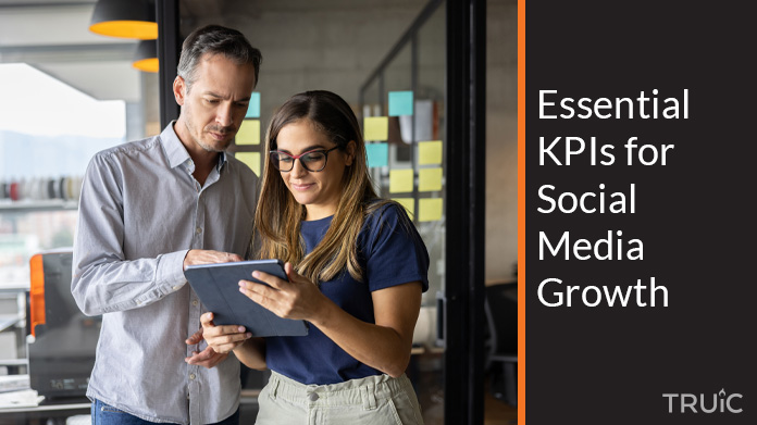 Two people looking at essential KPIs for social media growth.